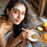 Woman applying home remedy to remove tan naturally from face using curd and gram flour in 2025
